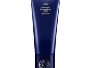 Oribe Supershine Moisturizing Cream i en blå tube med guldtekst, der beskriver produktet som en fugtgivende creme